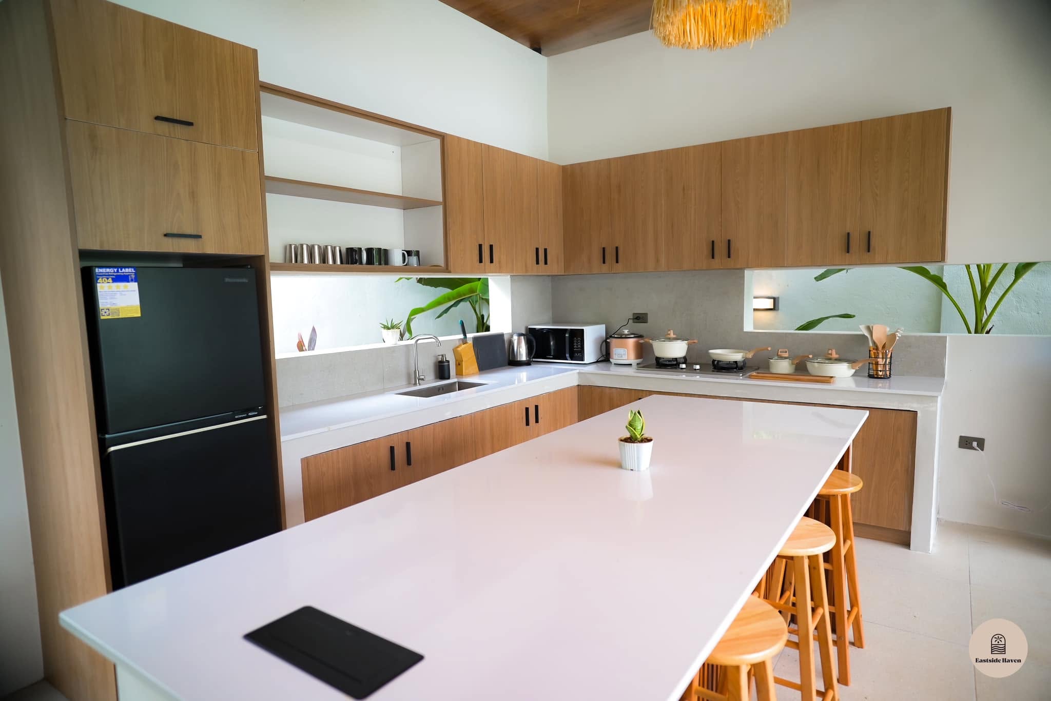 Kitchen with wood cabinetry and fridge